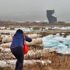 Woman taking picture of structure