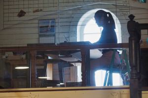 Silhouette of woman at table